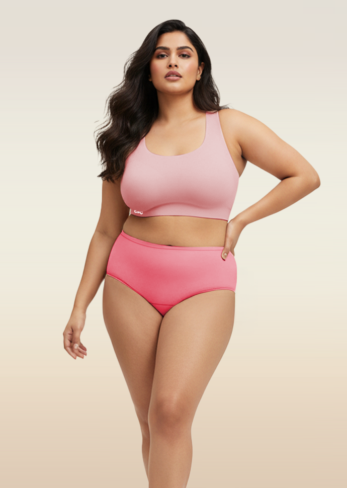 Woman wearing a pink bra and underwear set against a beige background