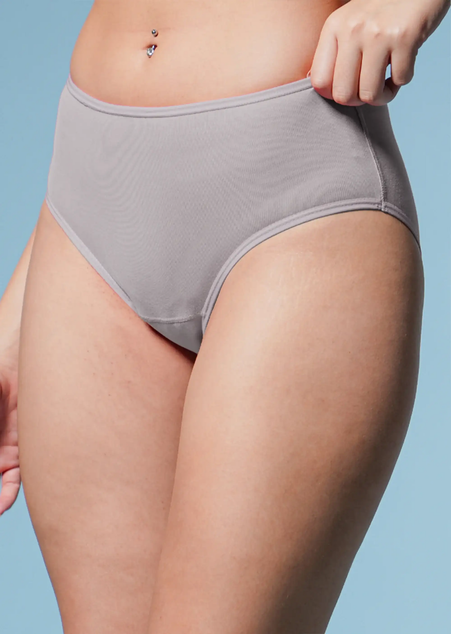 Person wearing gray underwear against a light blue background