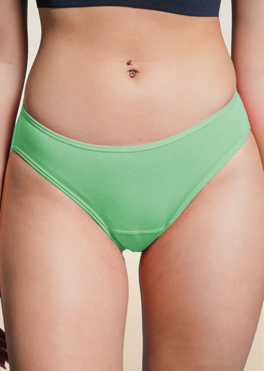 Green underwear worn by a person on a beige background