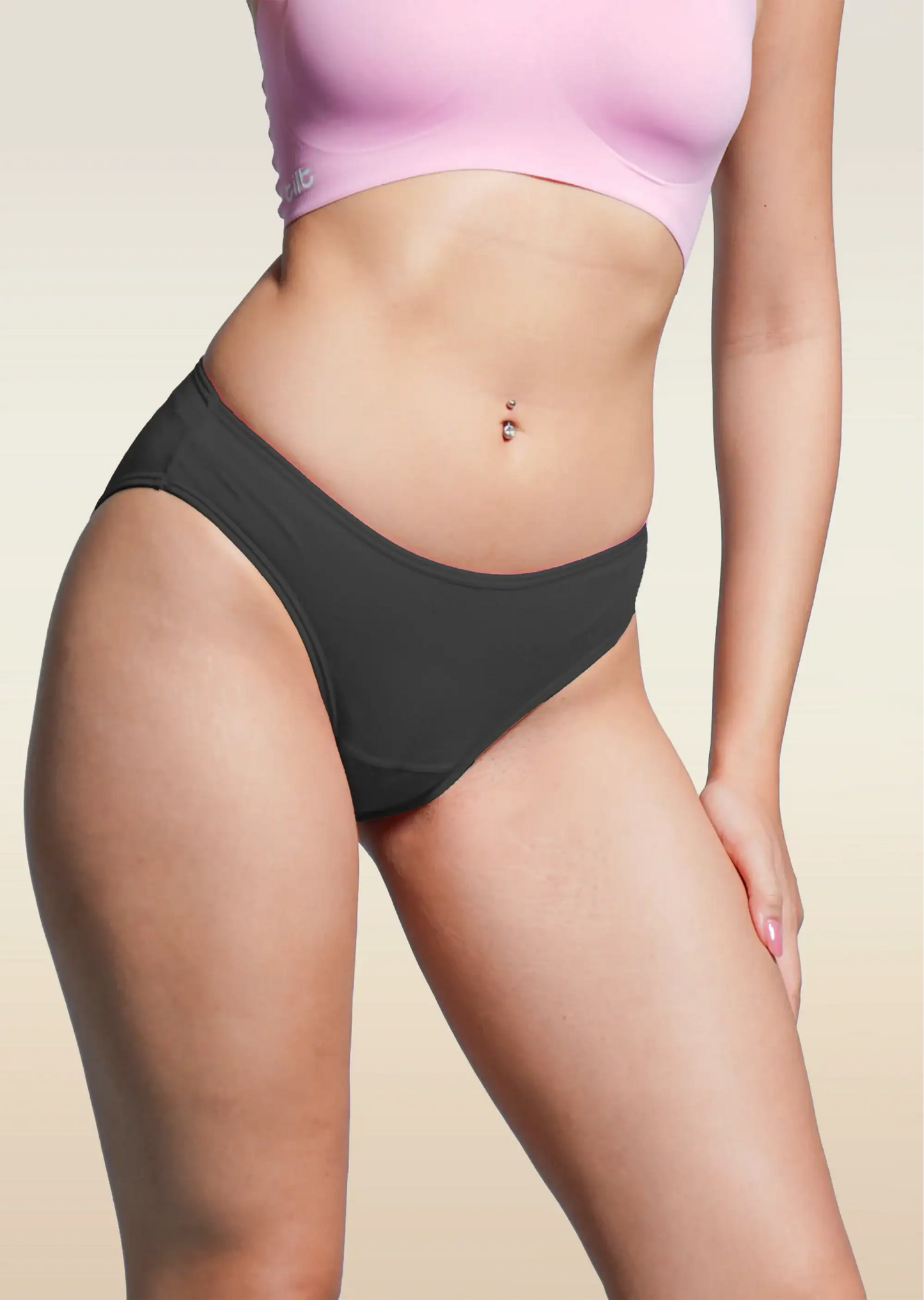Person wearing black underwear and a pink fursat bra on a beige background