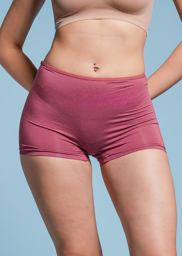 Person wearing red boyshorts on a light blue background