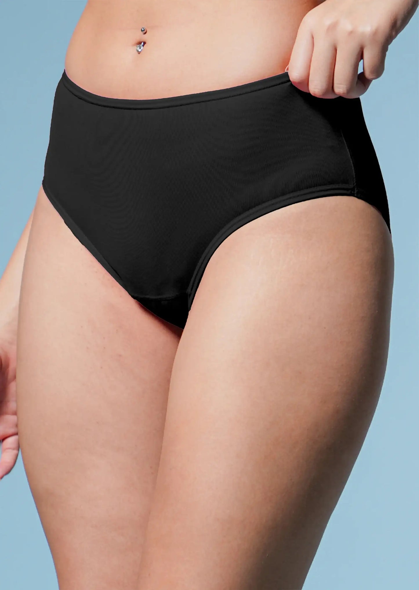 Person wearing black high-waisted underwear against a light blue background
