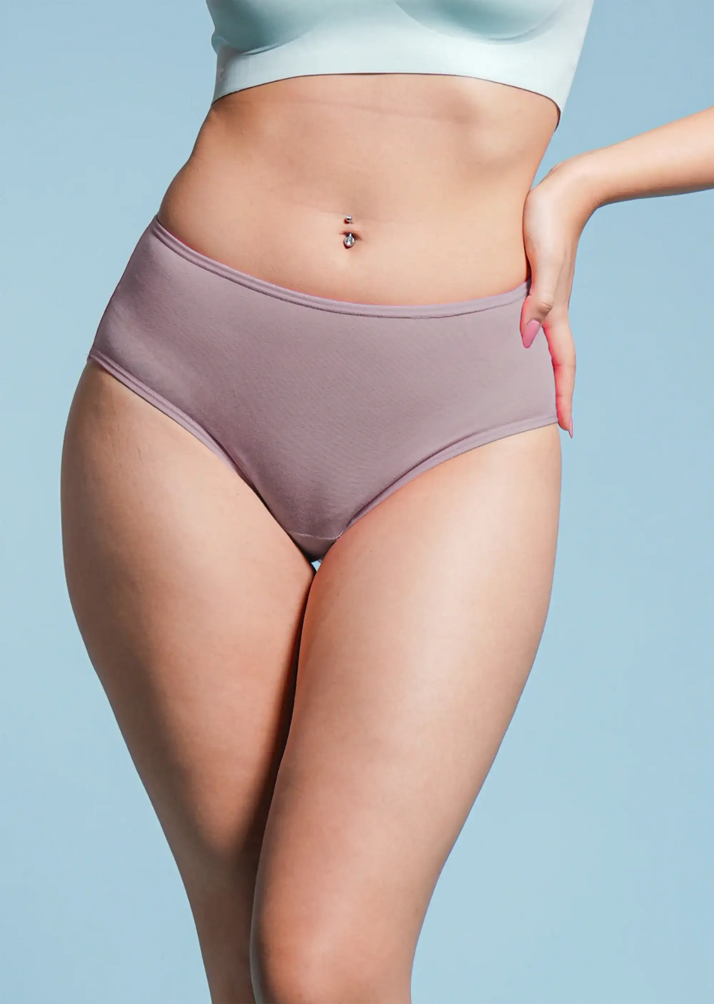 Person wearing a pair of brown underwear against a light blue background